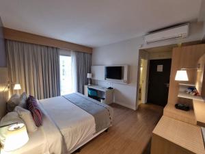 Stay Inn Santos Sua acomodação com cara de Hotel的电视和/或娱乐中心