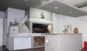 a kitchen with white cabinets and a counter top at Aires de Maipu in Maipú +26 photos