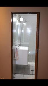 a bathroom with a shower and a tub and a sink at Aires de Maipu in Maipú