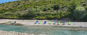 a group of lawn chairs sitting on a beach at Micro Africa Camping Site in Delvinë +17 photos