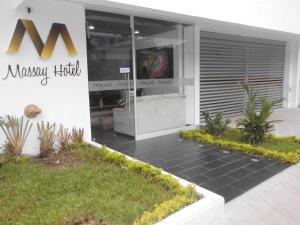 a mason habitat building with a sign on the side of it at Massay Hotel in Neiva