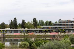 a building with a lake in front of it at Villa Duraku in Ulcinj