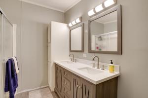 a bathroom with a sink and a mirror at Noteworthy Cabin Grill, Walk to Beaver Lake! in Rogers +23 photos