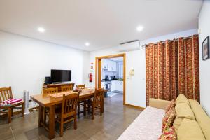 a living room with a table and a dining room at Sailorman and Friends in Ponta Delgada