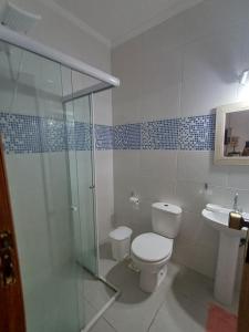 a bathroom with a toilet and a shower and a sink at BEIRA MAR APTO 711 in Ubatuba +118 photos