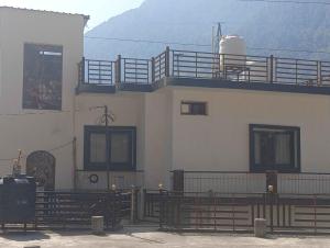 a building with a balcony on the side of it at Juyal palace in Jāmb