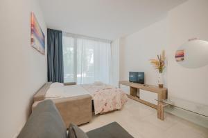 TV a/nebo společenská místnost v ubytování Vacanze Residence Mimose
