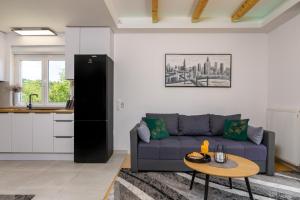 a living room with a couch and a table at Divine Apartment Drnis - "Modern comfort at the gateway to Krka National Park" in Drniš +31 photos