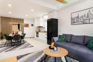 a living room with a couch and a table at Divine Apartment Drnis - "Modern comfort at the gateway to Krka National Park" in Drniš