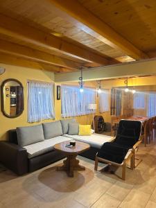 a living room with a couch and a table at Apartman Green River Banja Luka in Bijeli Potok