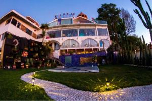a large building with lights in front of it at Hotel Temático Casa Puebla in Puebla