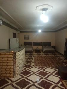 an empty room with a room with two beds at PYRAMIDS Villa T Medetion Camping in Banī Ghālib