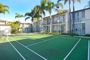 a tennis court with a tennis racket on it at Mandurah Motel and Apartments in Mandurah