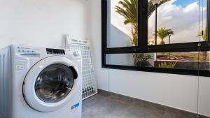 a washing machine in a bathroom with a window at Casa Amy-Costa Teguise in Costa Teguise