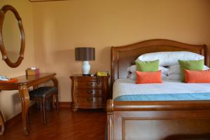 Postel nebo postele na pokoji v ubytování Sir James Resort