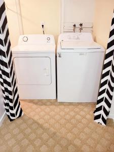 a laundry room with a washer and dryer at Excellence vacation home in St. John's +36 photos