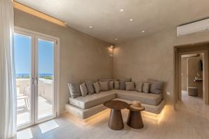 a living room with a couch and a table at Villa Adriana Hotel in Agios Prokopios