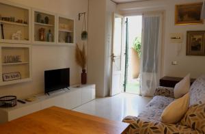 a living room with a couch and a tv at Il Glicine in Livorno
