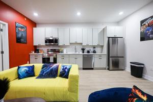 a living room with a yellow couch in a kitchen at Chill in Style Anime Themed Escape in Philadelphia