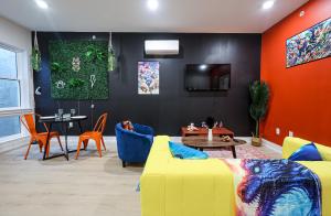 a living room with a yellow couch and a table at Chill in Style Anime Themed Escape in Philadelphia +14 photos