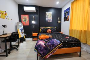 a bedroom with a bed and a desk in it at Chill in Style Anime Themed Escape in Philadelphia