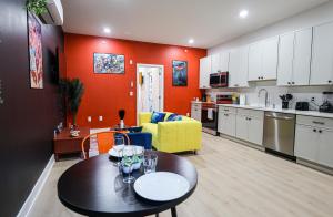 a kitchen and living room with a table and a couch at Chill in Style Anime Themed Escape in Philadelphia