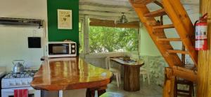 a kitchen with a counter top and a microwave at cabaña azul in Trevelín