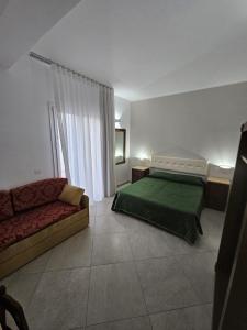 Ένα ή περισσότερα κρεβάτια σε δωμάτιο στο Alle Porte di San Vito