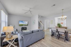 a living room with a couch and a table at Camaro in Orlando +26 photos