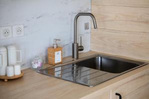 a kitchen counter with a sink in a kitchen at Coteaux en Vue in Aureville