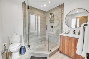 a bathroom with a shower and a toilet and a sink at Luxurious Townhome W/3 Master Suites gated Parking in Los Angeles +38 photos