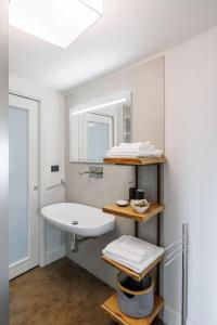 a bathroom with a sink and a mirror at Casa Dona - Essenza in Catania