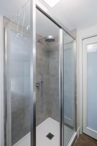 a shower with a glass door in a bathroom at Casa Dona - Essenza in Catania +33 photos