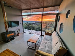 a living room with a couch and a large window at Villa Toscana I - Gran Vista y Tranquilidad in Villa Serrana
