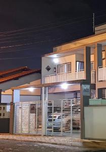 a building with a balcony with a car on it at Apart ZSS in Penha