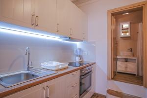 a kitchen with a sink and a counter top at Τhe Red dooR in Megali Ammos +29 photos