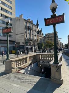 a street signs on a bridge in a city at GRAND APPARTEMENT de 120 m2 à 5 minutes du Metro 7 lits in Les Lilas