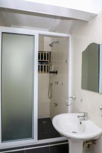 a bathroom with a glass shower and a sink at Capricorn Heights BnB 2 bedrooms Apartment at Kwabenya, Accra, Balloon Gate in Kwabenya