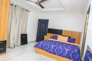 a bedroom with a bed and a black door at Capricorn Heights BnB 2 bedrooms Apartment at Kwabenya, Accra, Balloon Gate in Kwabenya