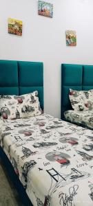 a bedroom with a bed with a comforter on it at TIM Haute standing appartment S2, center Monastir in Monastir