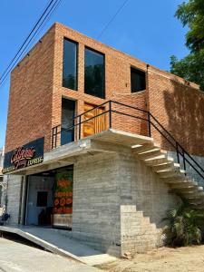 a brick building with stairs on the side of it at Modern loft with AC Close to downtown Huatulco in Santa Maria Huatulco