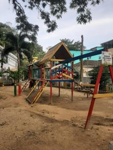 a playground with a house and a slide at Casa em Mangaratiba RJ - 40 metros da Praia in Mangaratiba +23 photos