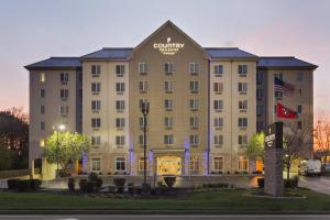 a building with a sign on the front of it at Country Inn & Suites by Radisson Nashville Airport TN in Nashville