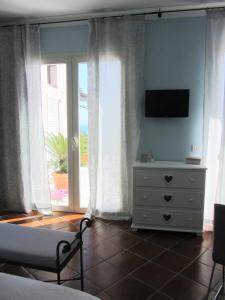 TV a/nebo společenská místnost v ubytování b&b I Limoni