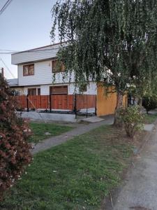 a house with a fence in front of it at Casablanca in Temuco