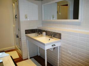 a bathroom with a sink and a mirror at Apartments Suites in Antwerp in Antwerp +42 photos