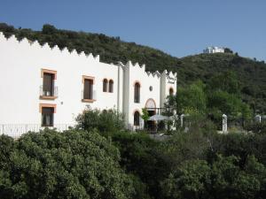 a large white house with trees at Hotel Sierra de Araceli Lucena in Lucena