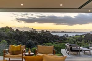 a living room with a view of the ocean at Number 29 in Oneroa