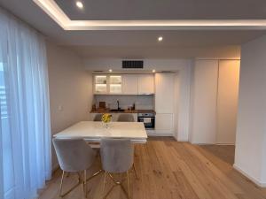 a kitchen with a white table and two chairs at The Royal Nest Sarajevo Waves in Sarajevo