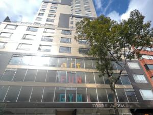 a tall building with a sign on the side of it at Panoramic Luxury of Bogotá in Bogotá
